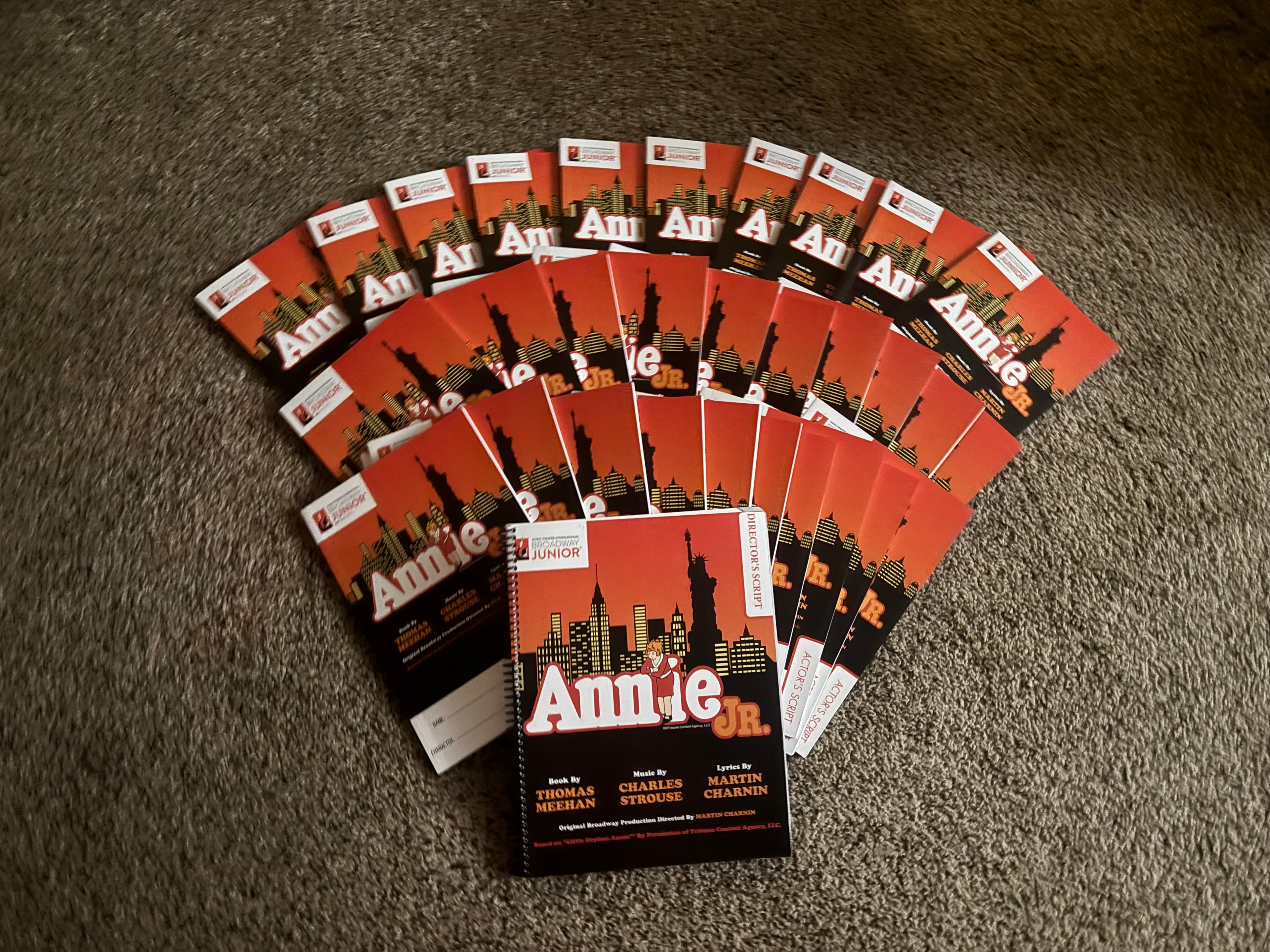 Annie Jr. script booklets fanned out